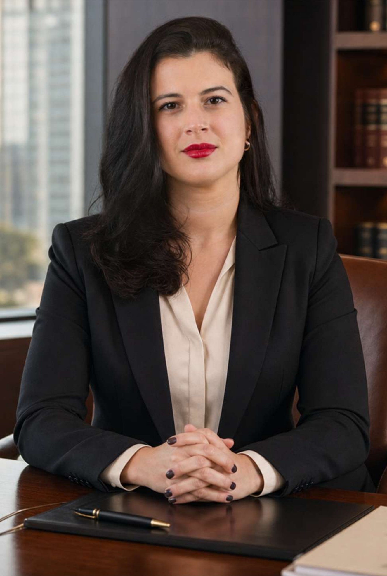 Keila Kremer sentada à sua mesa de trabalho